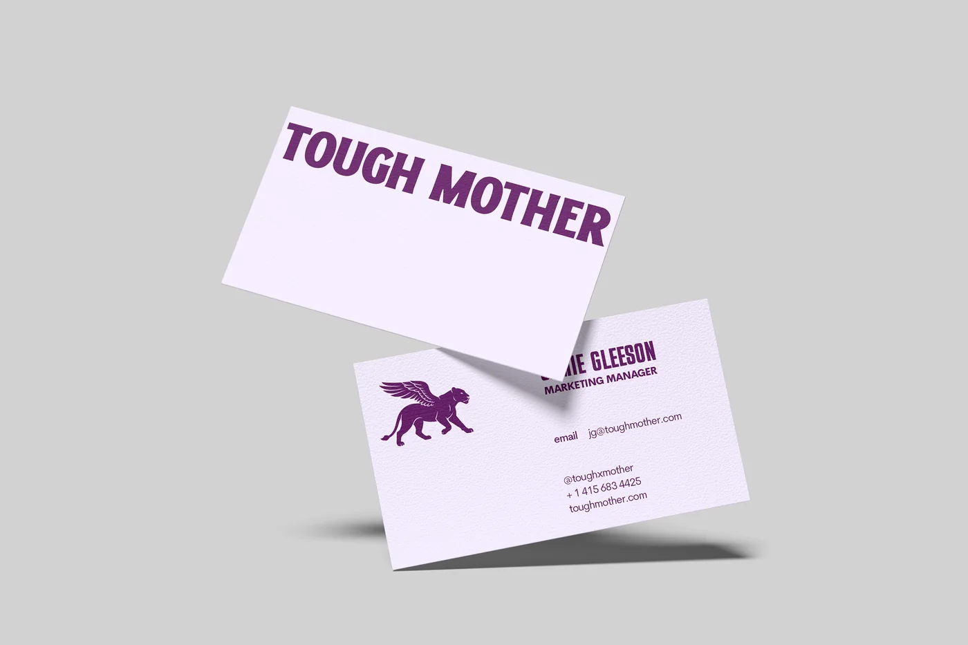 Two Tough Mother business cards, the wordmark on one and the winged lioness with contact details on the other